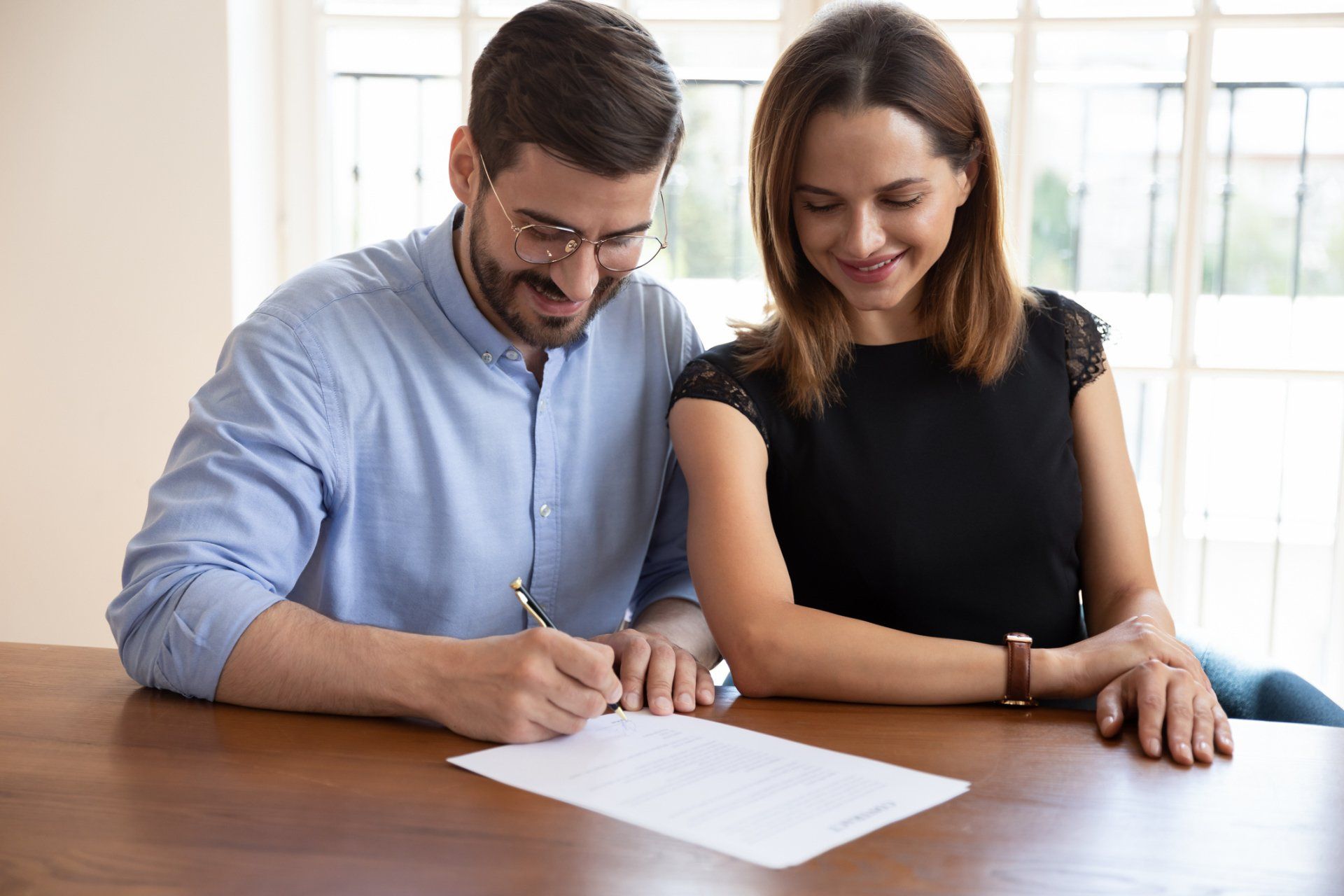 Happy Married Couple Signing Contract — Newark, CA — Daniel Kisner Law