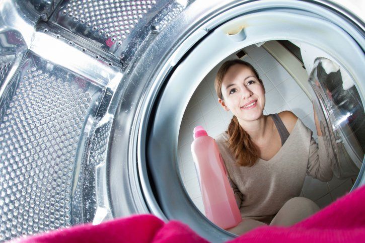 Young woman doing laundry - Washing & Folding Services in Rockland, Maine