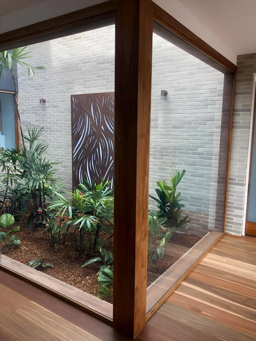 A Room With A Large Window Looking Out To A Garden — Pavy's Glass In Port Macquarie, NSW