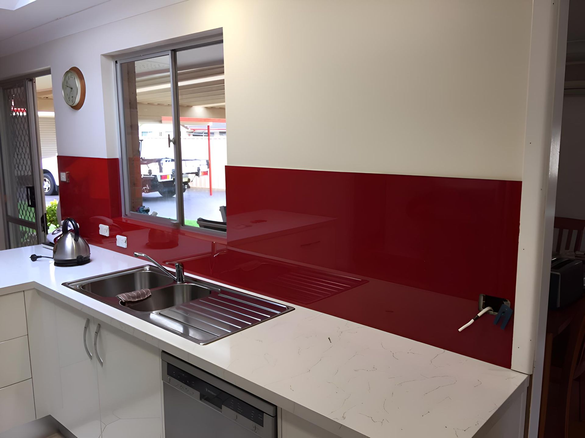 A Kitchen With A Red Backsplash And White Cabinets — Pavy's Glass In Port Macquarie, NSW