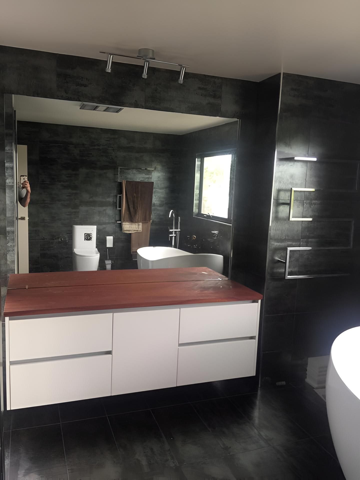A Bathroom With A Large Mirror And A Bathtub — Pavy's Glass In Port Macquarie, NSW