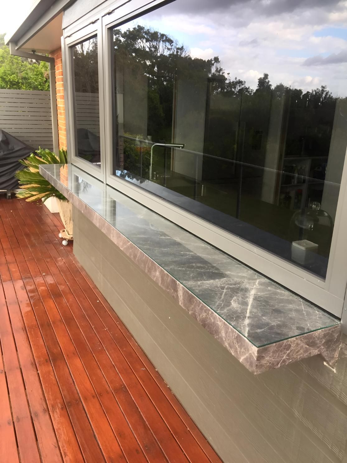 A Wooden Deck With A Window On The Side Of A House — Pavy's Glass In Port Macquarie, NSW