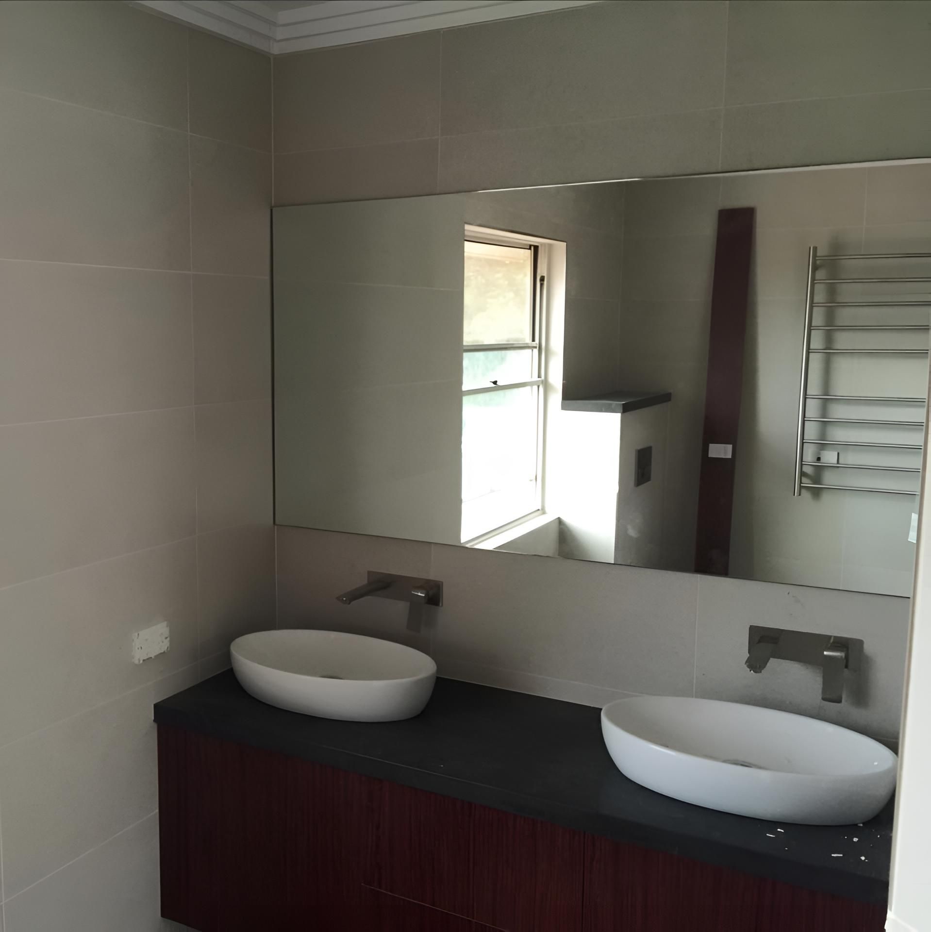 A Bathroom With Two Sinks And A Large Mirror — Pavy's Glass In Port Macquarie, NSW