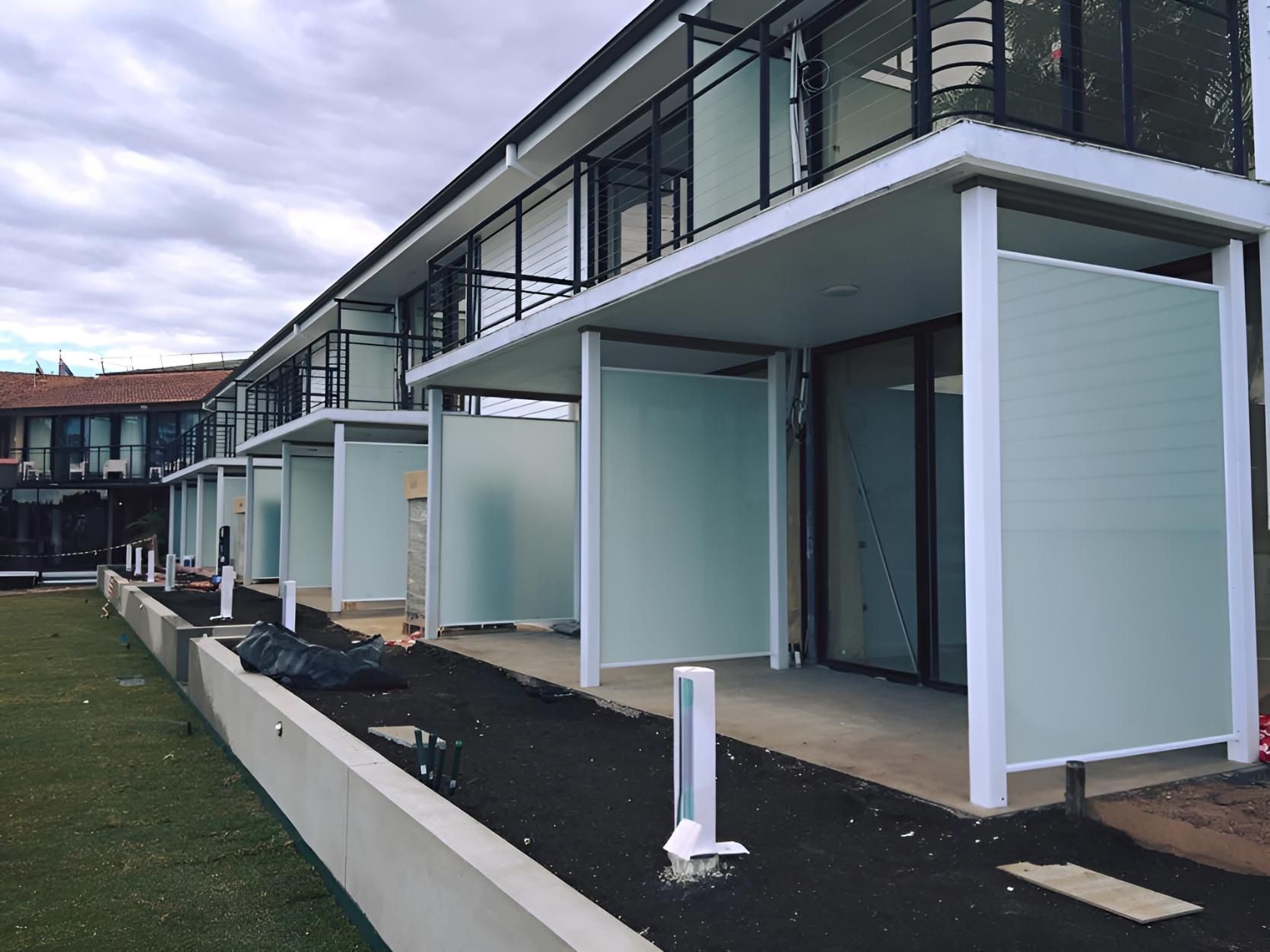 A Building With A Lot Of Windows And A Fence — Pavy's Glass In Port Macquarie, NSW