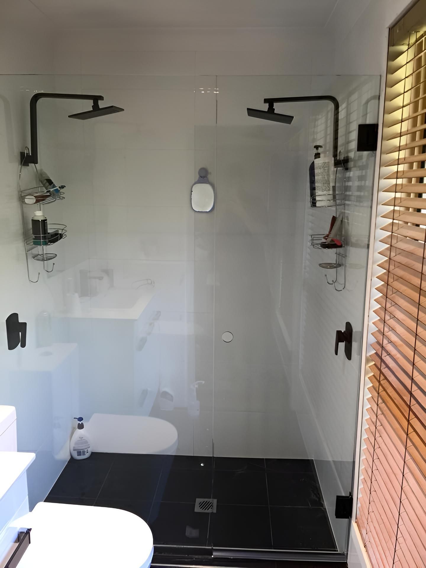 A Bathroom With A Walk In Shower , Toilet And Sink — Pavy's Glass In Port Macquarie, NSW