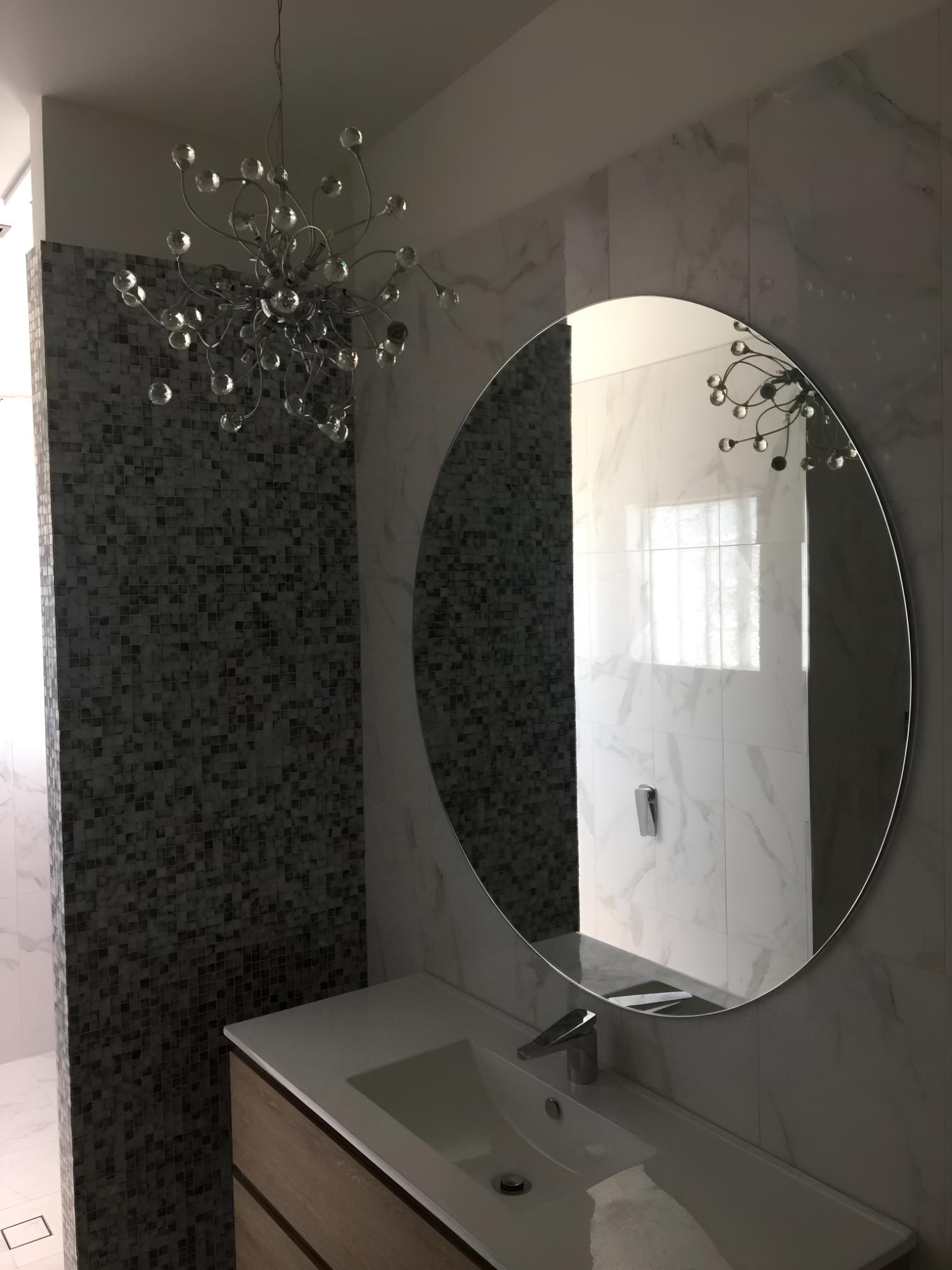 A Bathroom With A Sink , Mirror And Chandelier — Pavy's Glass In Port Macquarie, NSW