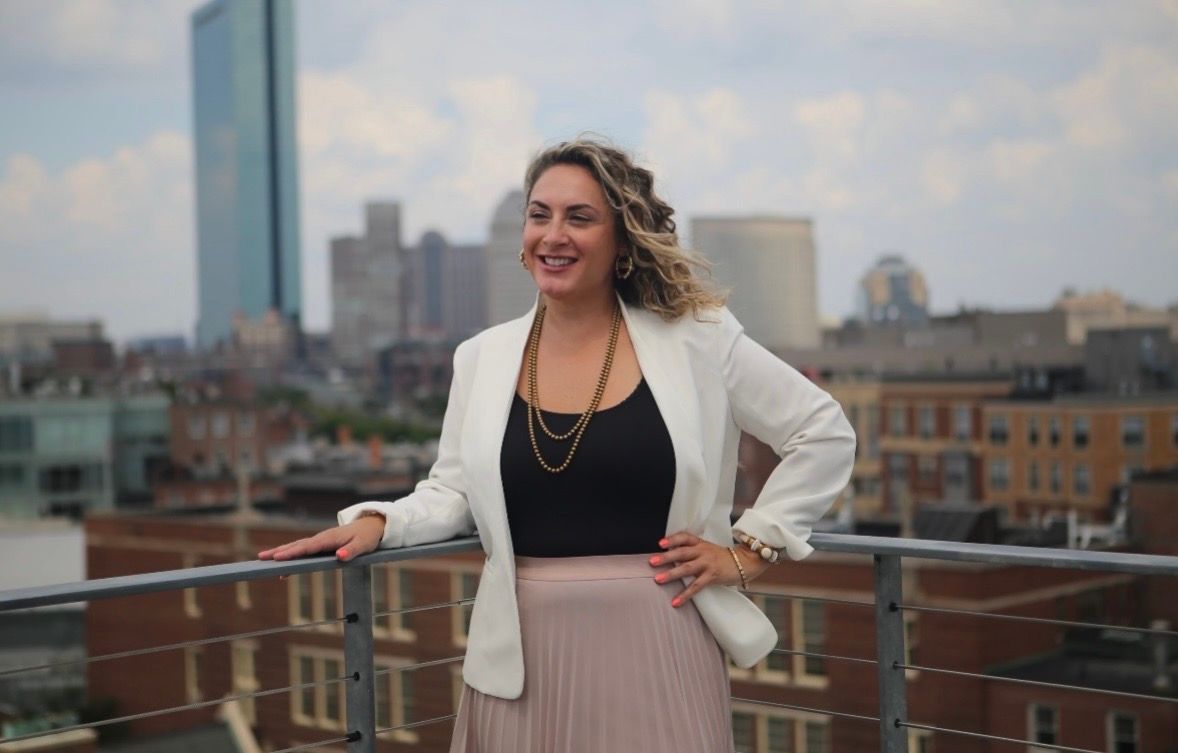 A man with a beard is wearing a blue jacket and tie.