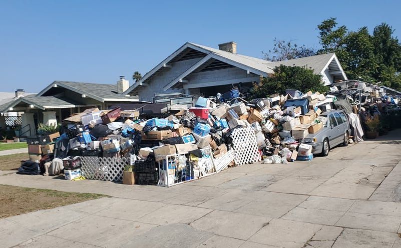 a house with a lot of garbage in front of it