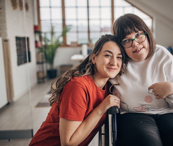 aid and girl in wheelchair