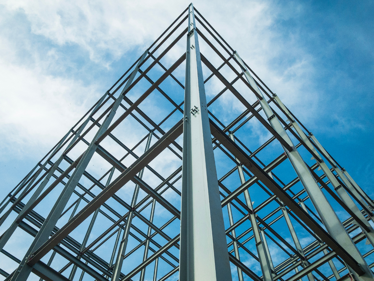 Looking up at a building under construction with a blue sky in the background Looking up at a building under construction with a blue sky in the background