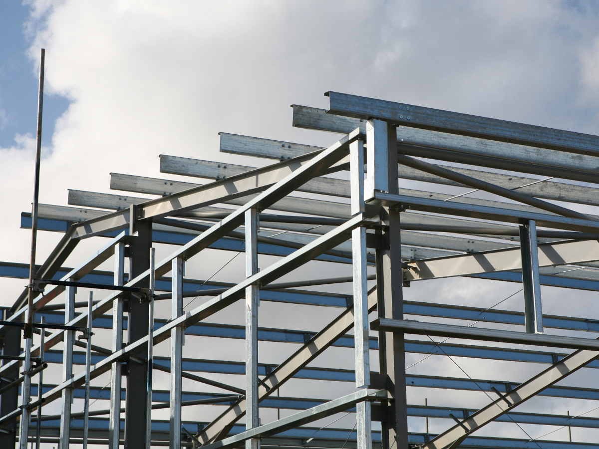 A metal structure under construction with a blue sky in the background