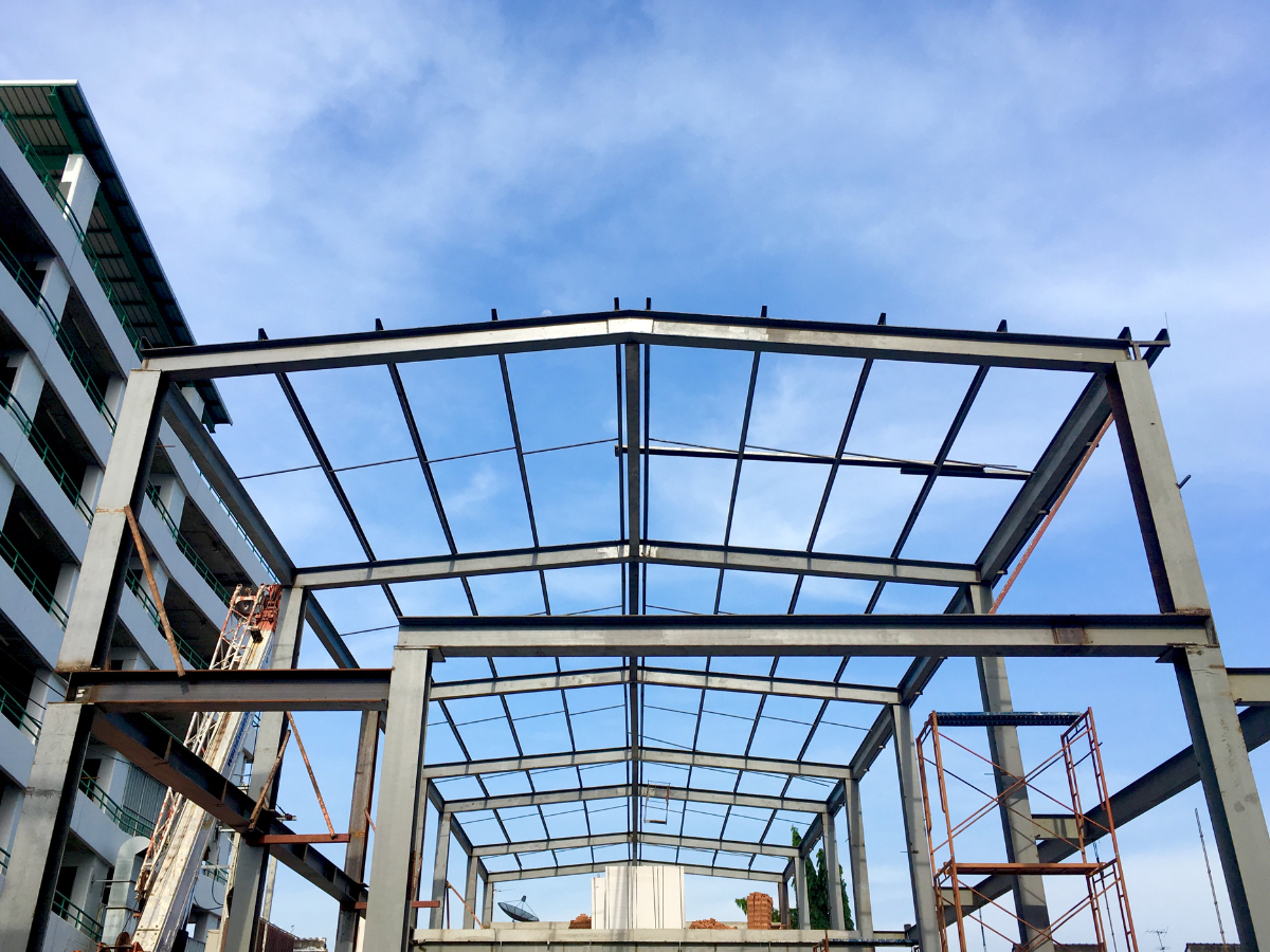 A building under construction with a blue sky in the background.