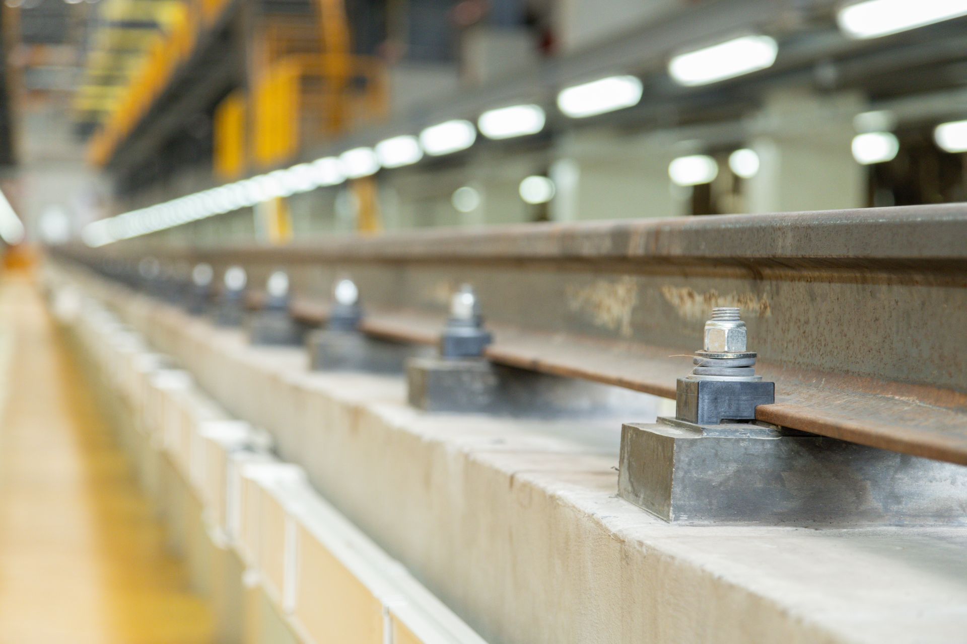 A close up of a train track with nuts and bolts on it.