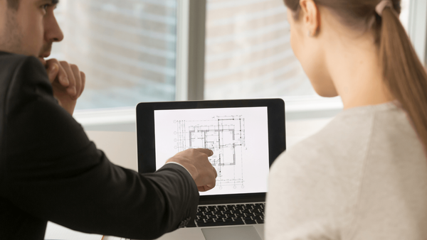 Man showing a woman home remodeling plans