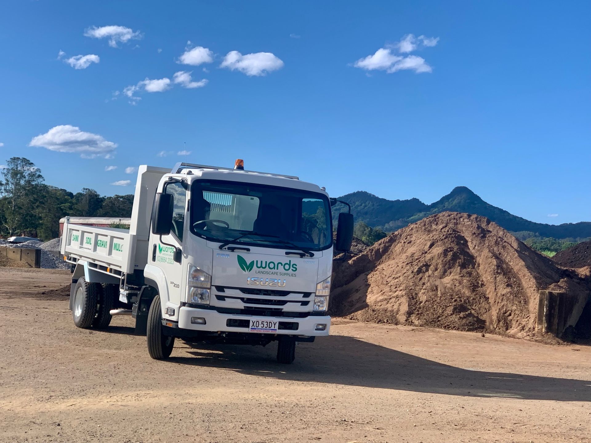 Gardener Fertilising the Plants — Landscaping Supplies in Myocum, NSW