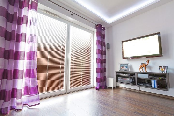 wall-mounted tv system next to large windows