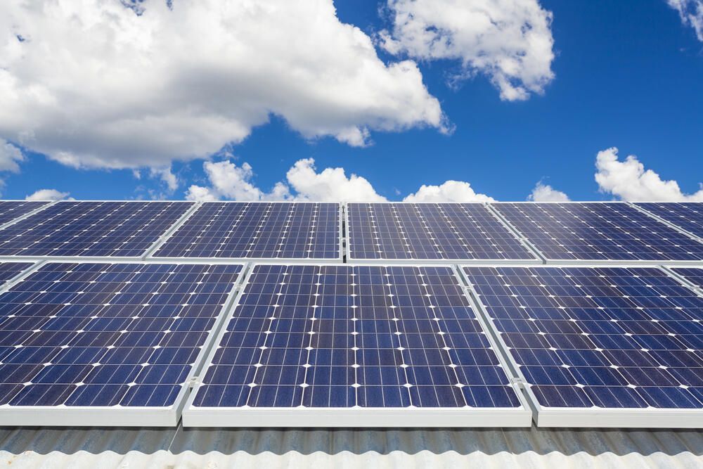 Row of Solar Panels Against a Blue Sky With Clouds — Abstract Window Cleaning in Tweed Heads, NSW
