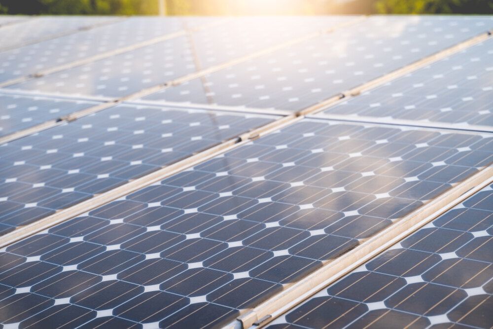 Row of Solar Panels on a Roof With the Sun Shining Through Them — Abstract Window Cleaning in Murwillumbah, NSW