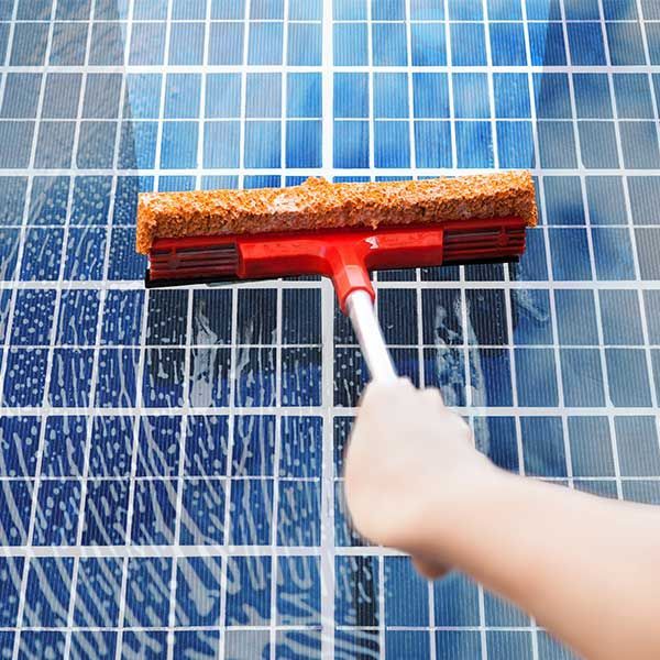 Person is Cleaning a Tiled Floor With a Squeegee — Abstract Window Cleaning in Hopkins Creek, NSW