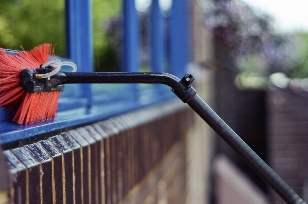 Red Brush is Being Used to Clean a Window — Abstract Window Cleaning in Hopkins Creek, NSW