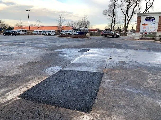 A parking lot with a large hole in the middle of it.