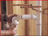 Plumber installing new PVC pipes