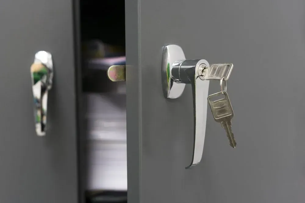 Gray Metal Cabinet With a Handle and Keys in the Lock — Shaine Hunter Locksmiths in Richmond, QLD