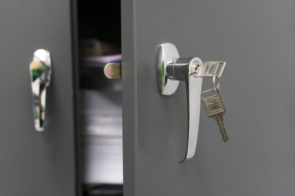 Gray Cabinet Doors, One Open, With a Shiny Silver Handle and Keys — Shaine Hunter Locksmiths in Normanton, QLD