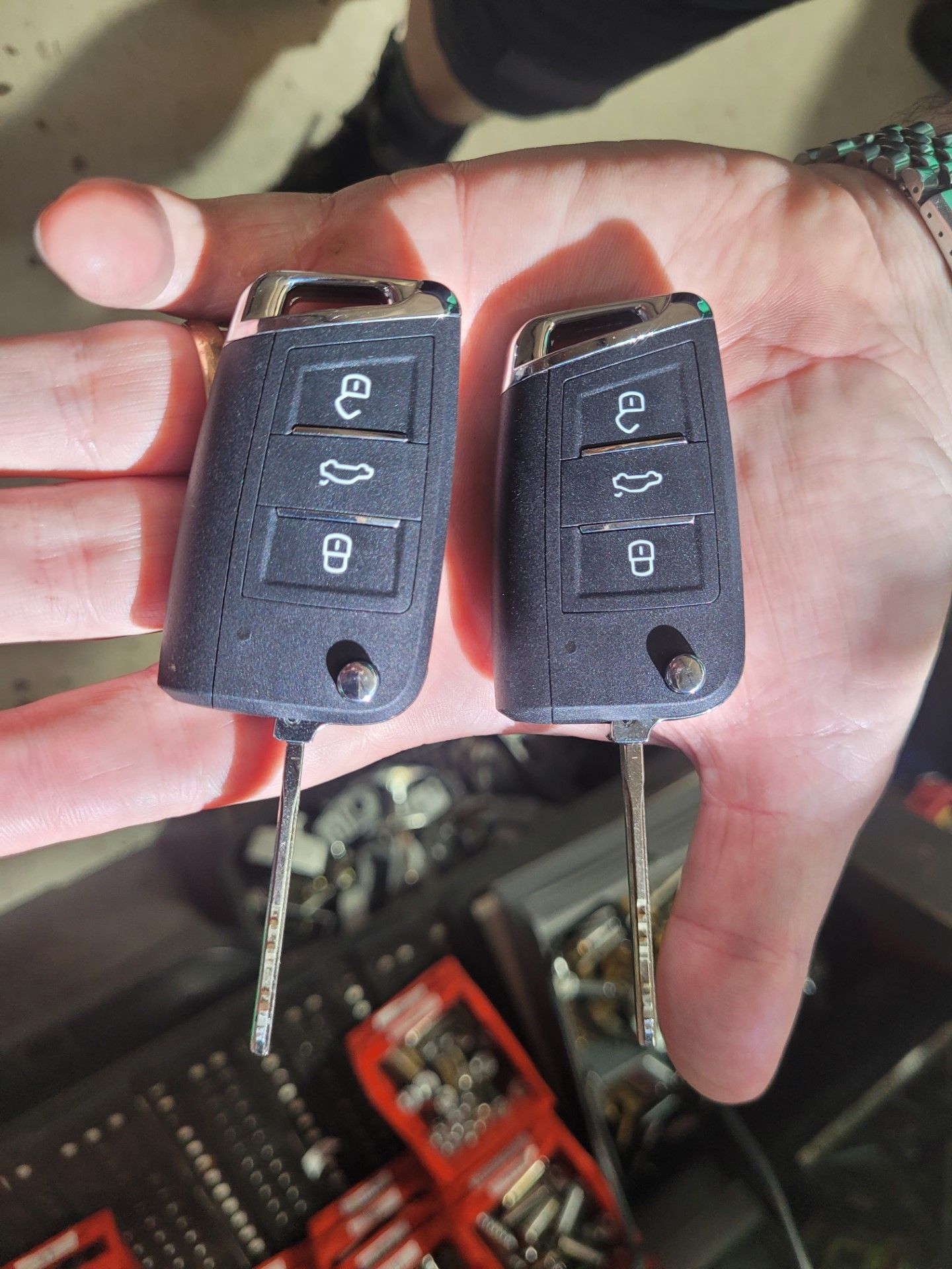 Two Car Keys Held in a Person's Hand, Against a Blurred Background — Shaine Hunter Locksmiths in Cloncurry, QLD
