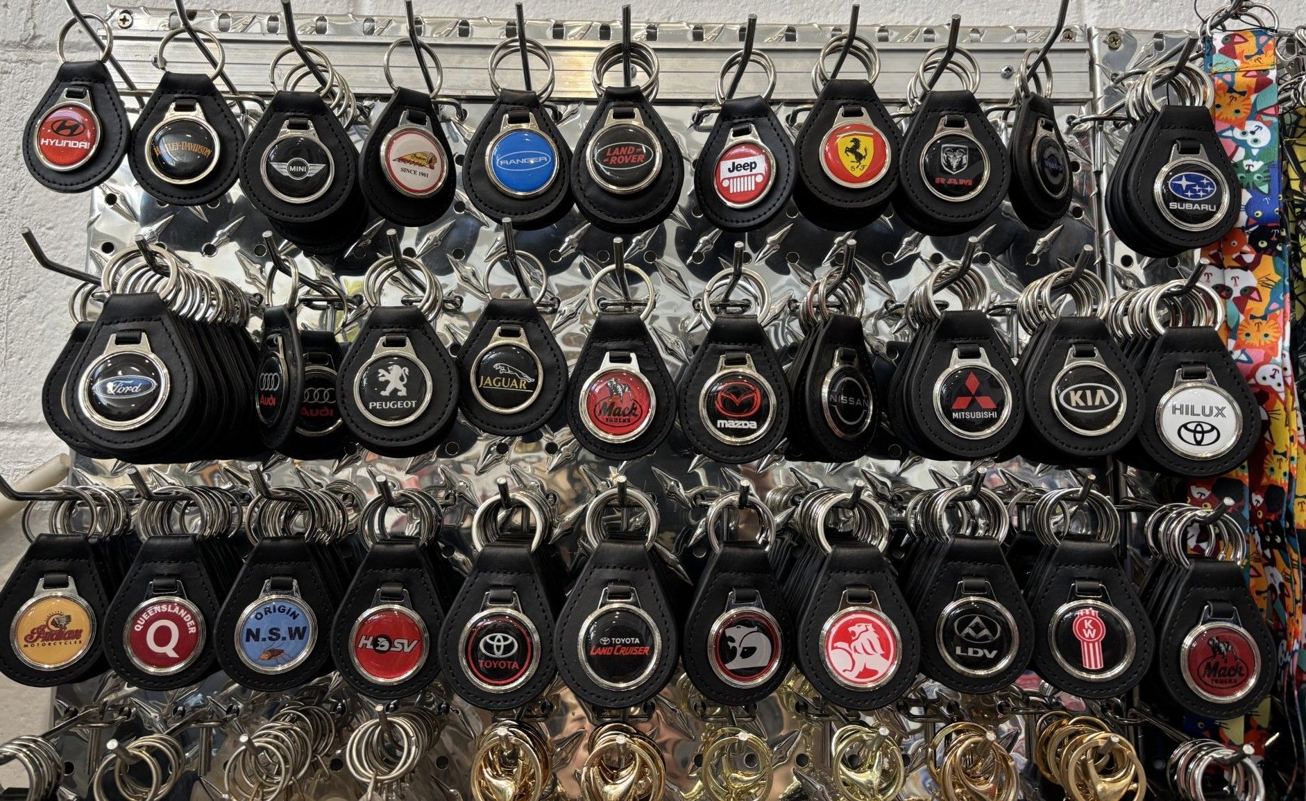 Display of Car Brand Keychains With Various Logos on Black Leather — Shaine Hunter Locksmiths in Doomadgee, QLD