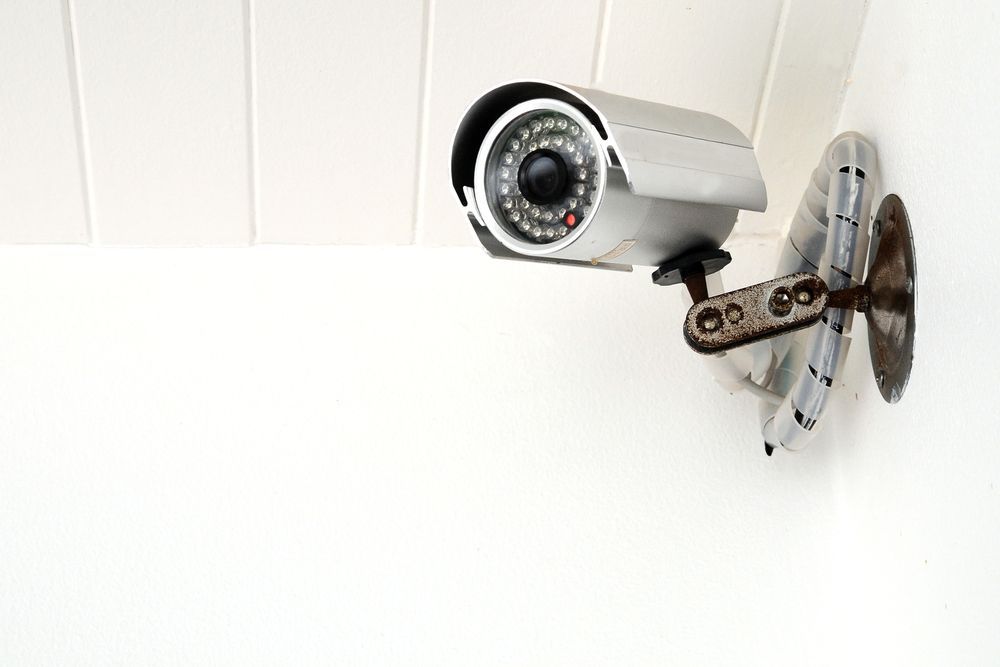 Security Camera Mounted on a White Wall — Shaine Hunter Locksmiths in Winton, QLD