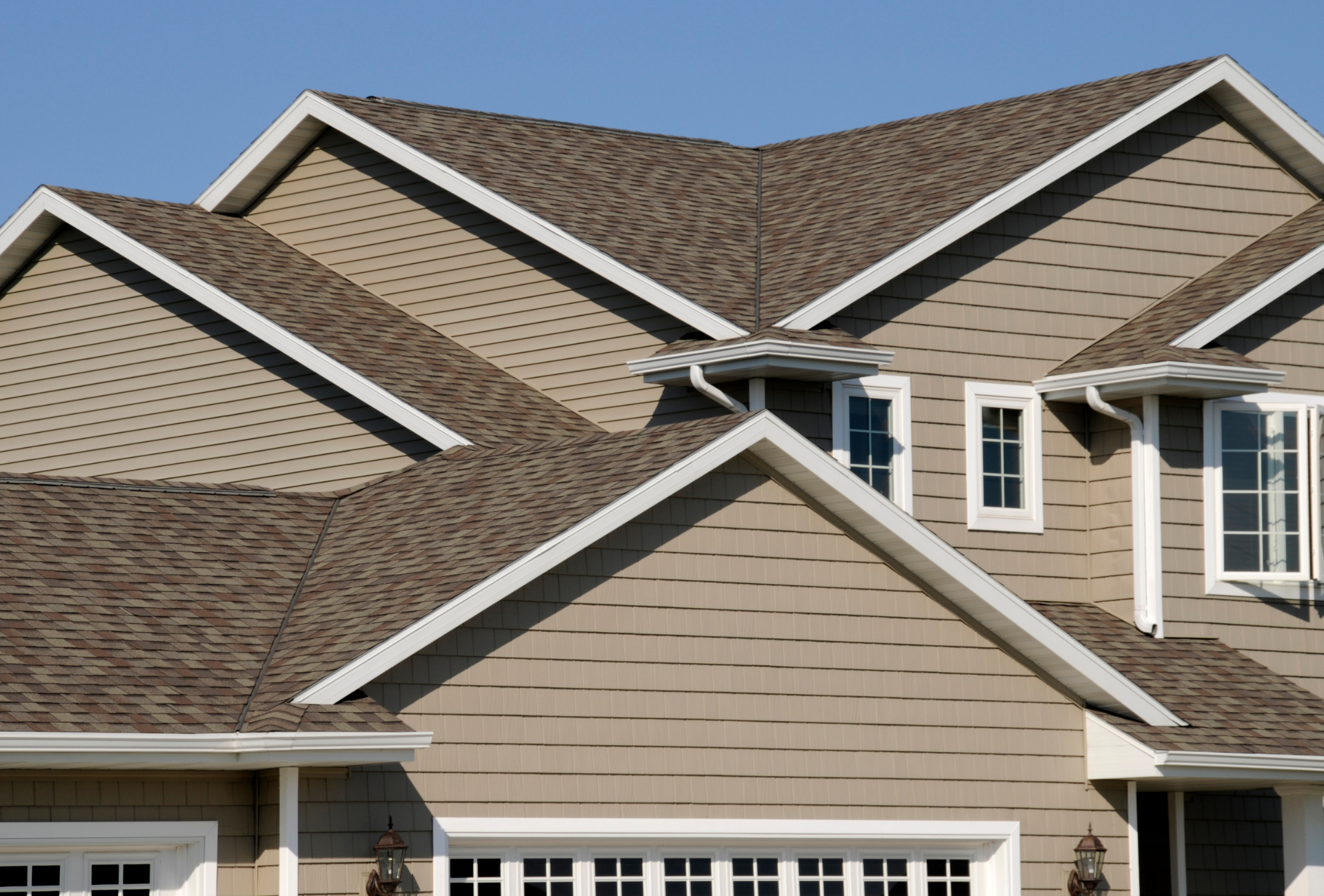 A house with a brown roof and white trim