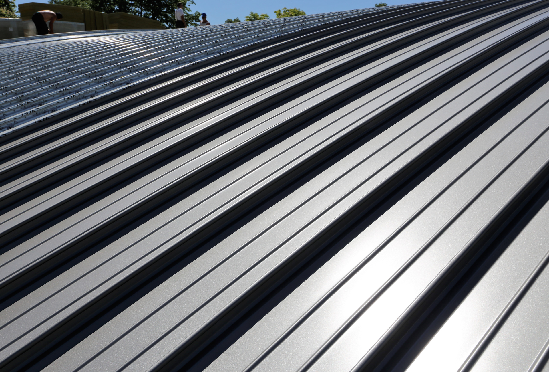 A close up of a metal roof with black stripes