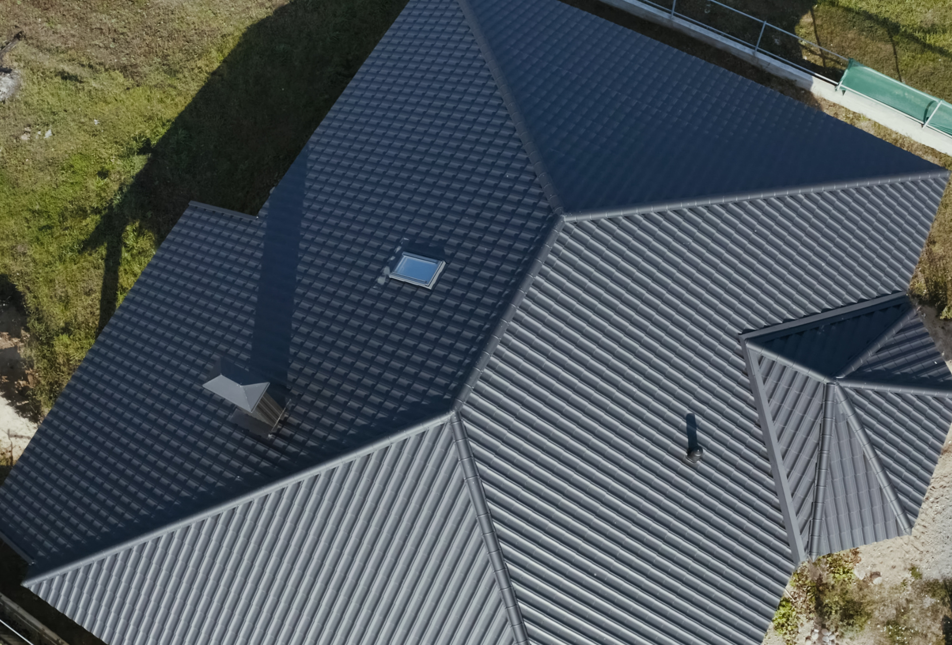 An aerial view of a house with a gray roof
