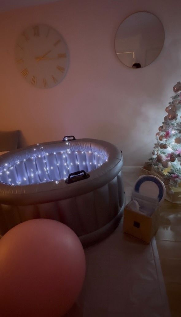 A room with a birthing pool and a christmas tree