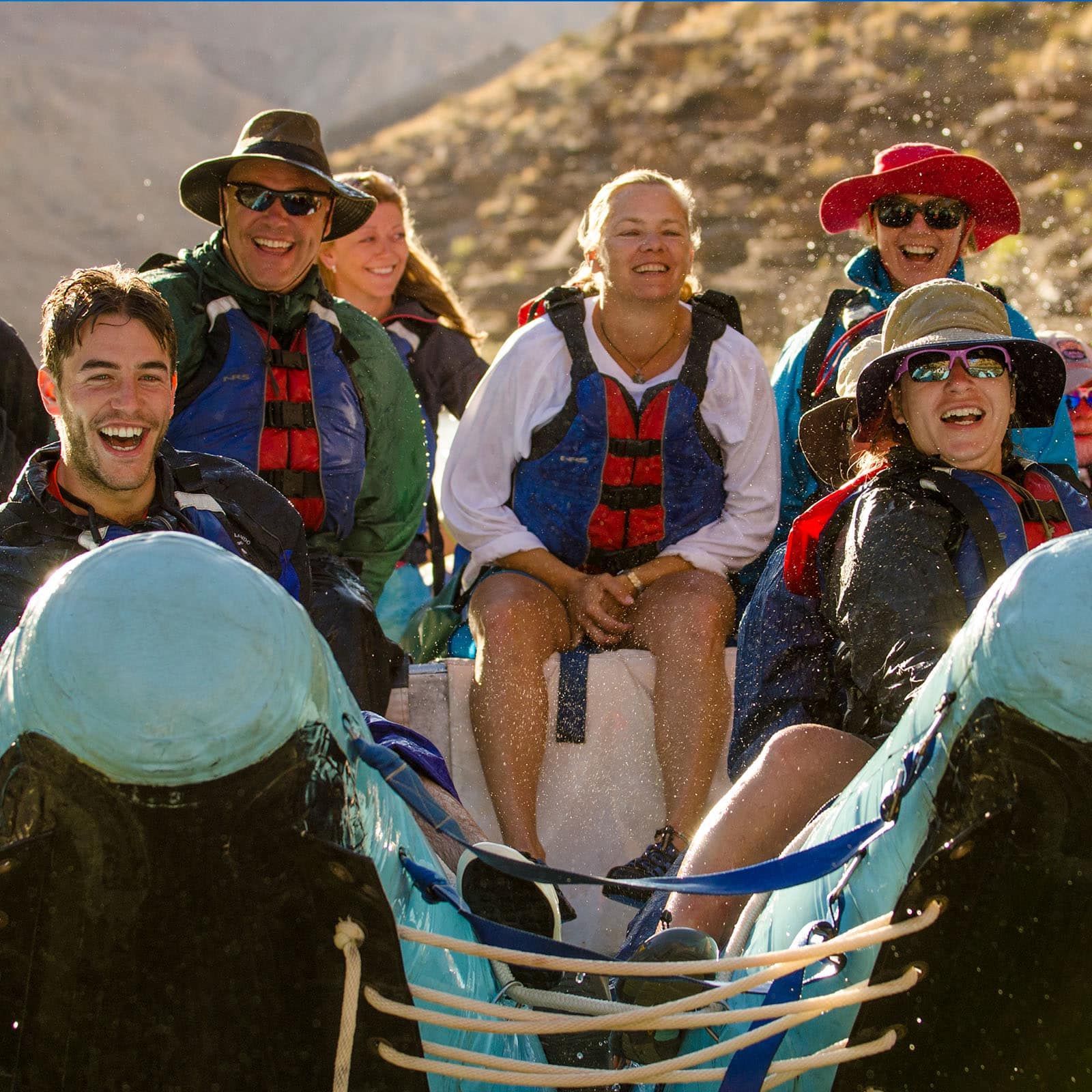 smiling people on a raft