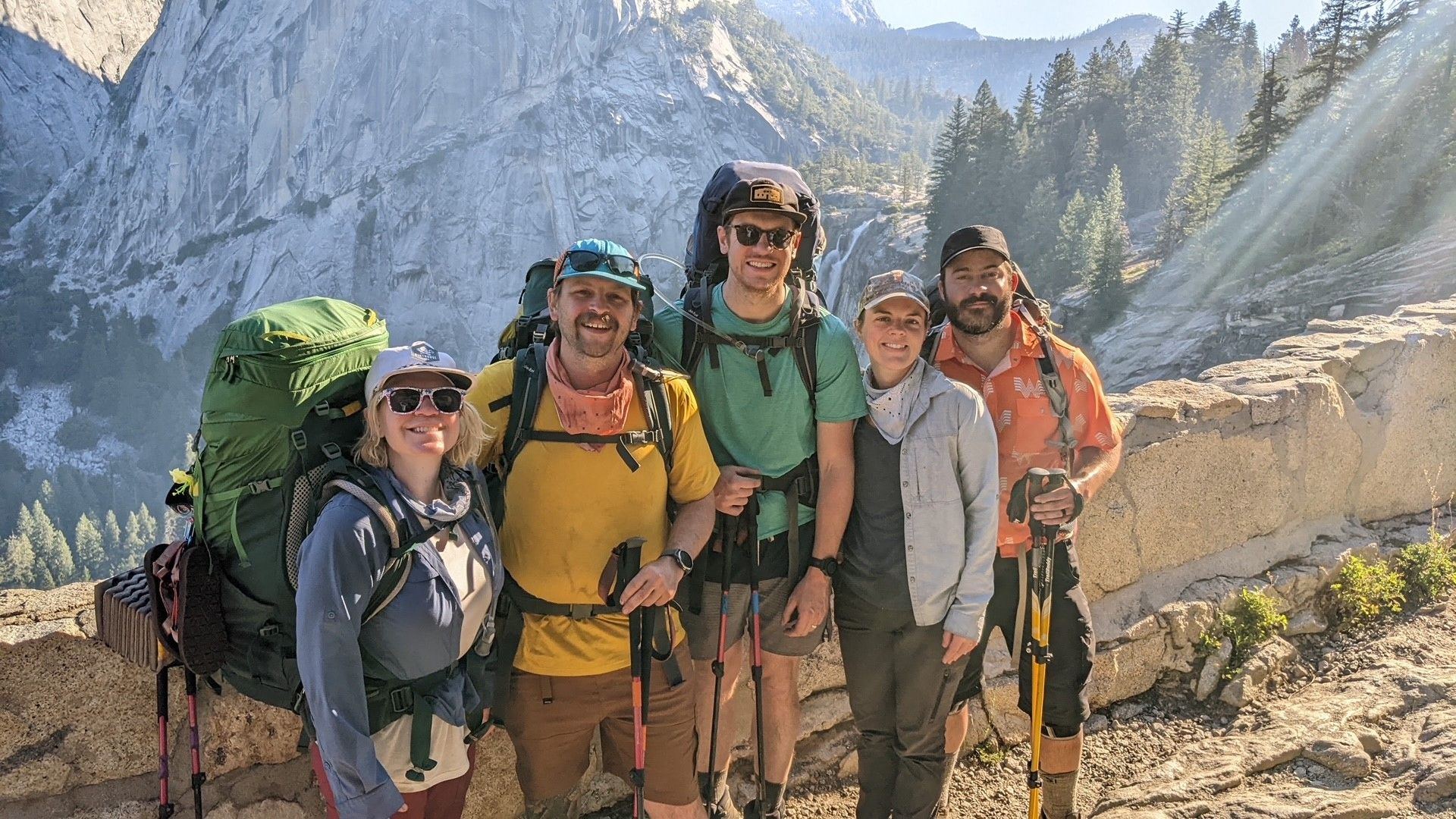 a group of tourist smiling in front of mountains