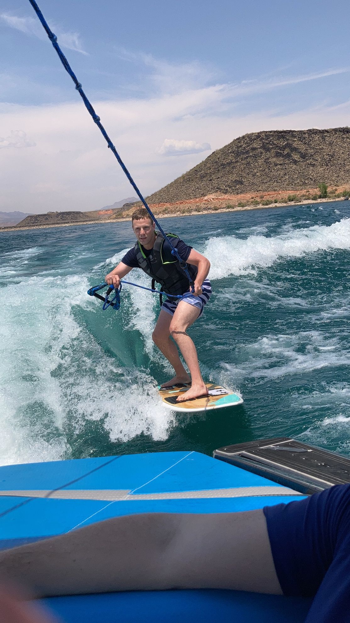 A man is riding a wave on a wakeboard in the ocean.