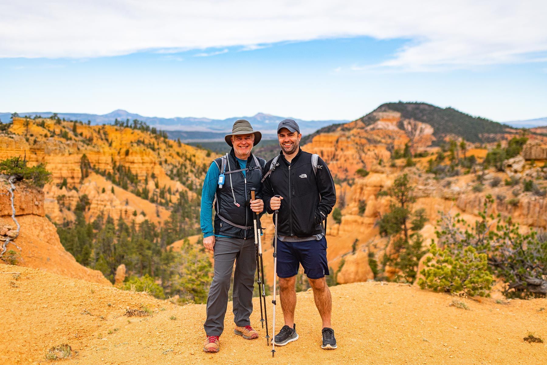 A mother and daughter are hiking together with backpacks
