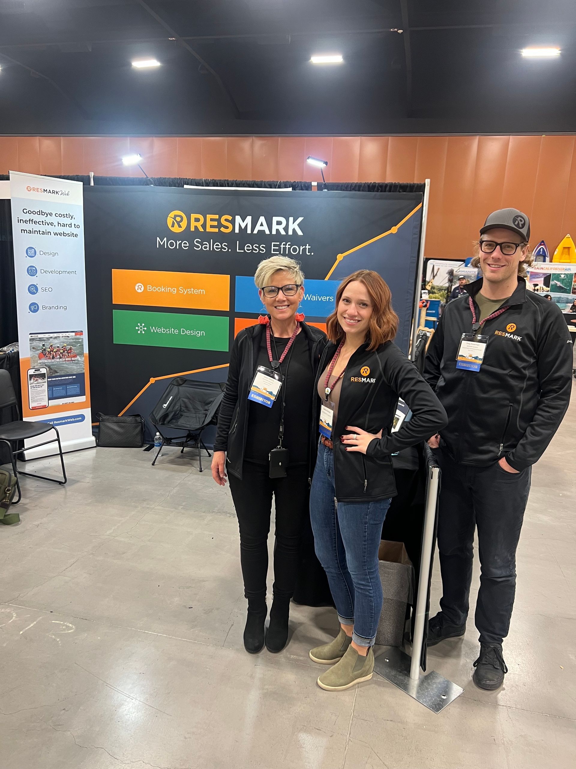 Resmark employees standing in front of tradeshow banner at the America Outdoors Conference