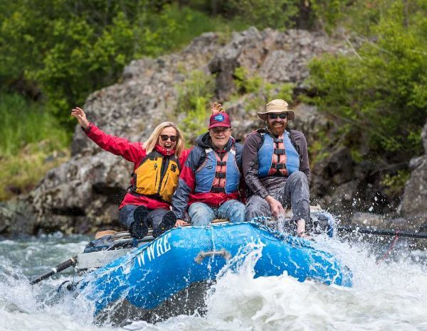 A group of people are riding a raft down a river