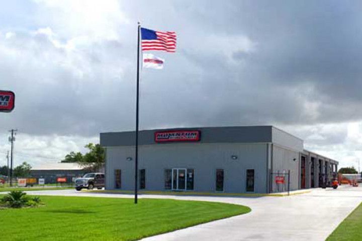 An american flag is flying in front of a building.
