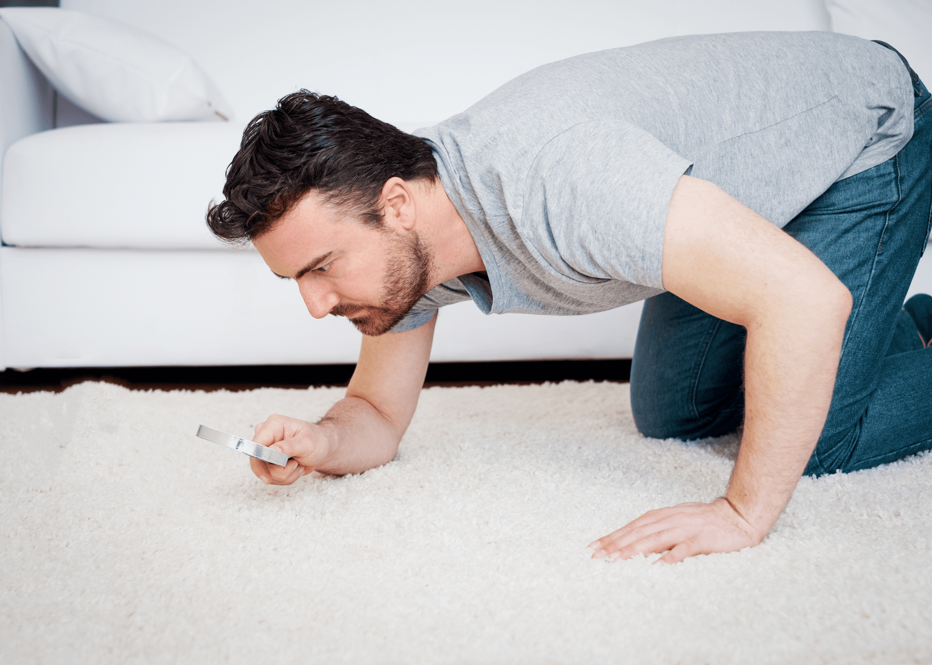 man-on-floor-with-magnifying-glass