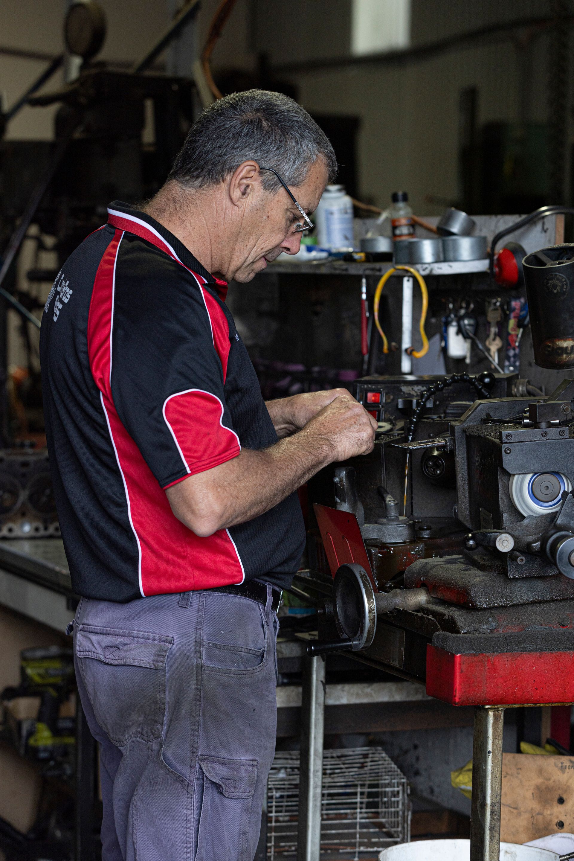 Auto Mechanic Testing Electrical System on Automobile— Currie Bros Engine Reconditioners in Taree, NSW 