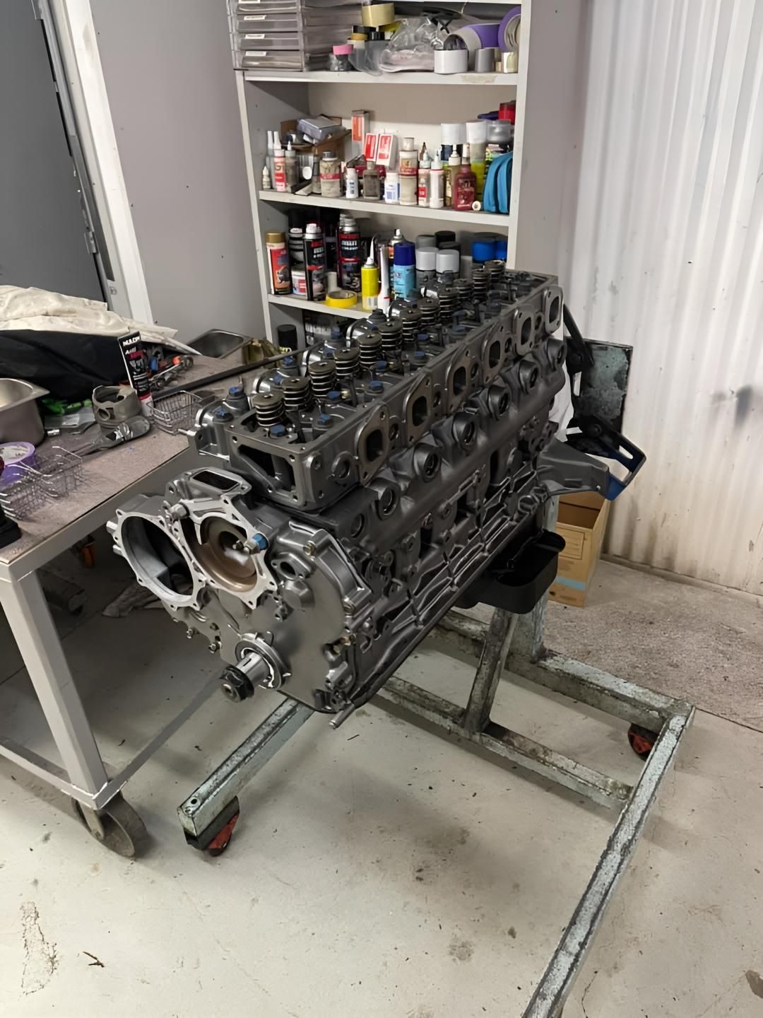 A Large Engine is Sitting on a Stand in a Garage — Currie Bros Engine Reconditioners in Gloucester, NSW