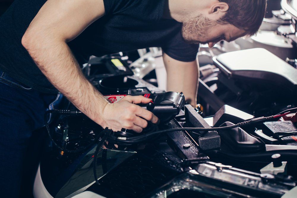 Auto Mechanic Testing Electrical System on Automobile — Engine Reconditioning in Taree, NSW