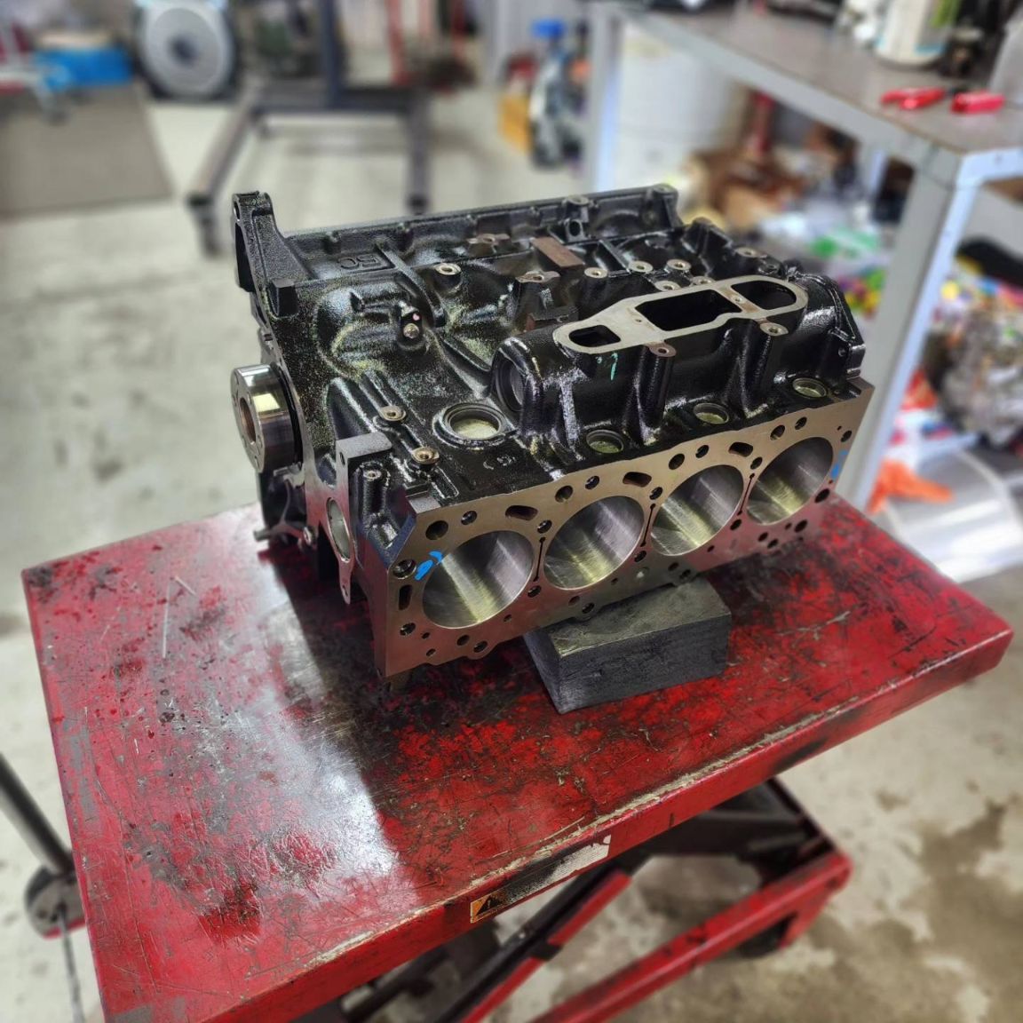 A Cylinder Block is Sitting on Top of a Red Table — Currie Bros Engine Reconditioners in Hallidays Point, NSW