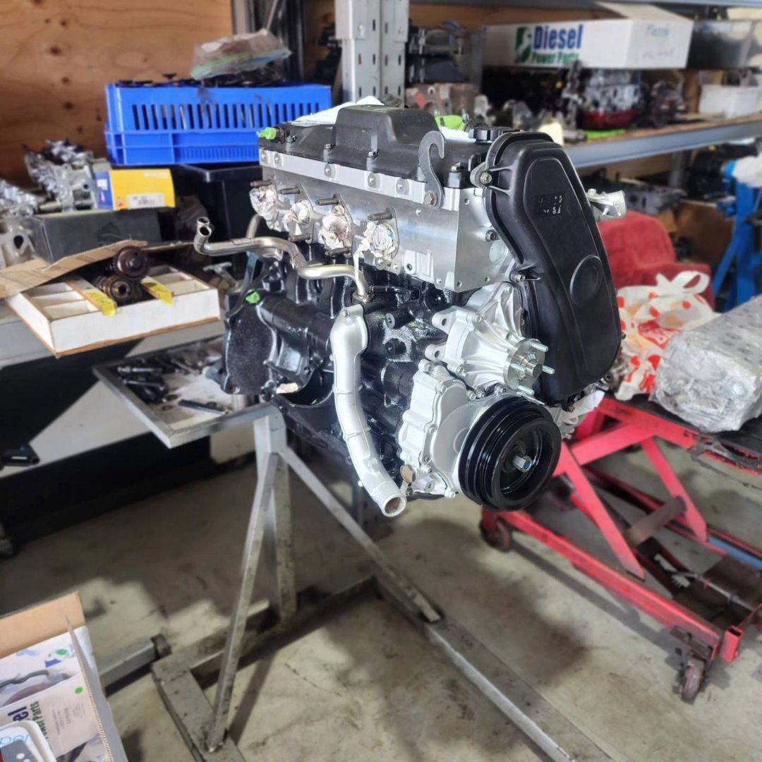 A Diesel Box Sits on a Shelf Next to a Engine — Currie Bros Engine Reconditioners in Taree, NSW