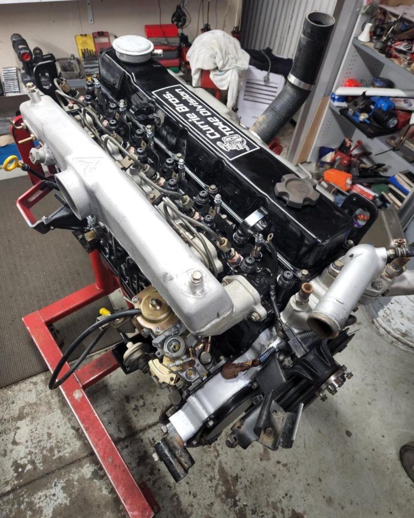 An Engine is Sitting on a Red Stand — Currie Bros Engine Reconditioners in Kempsey, NSW