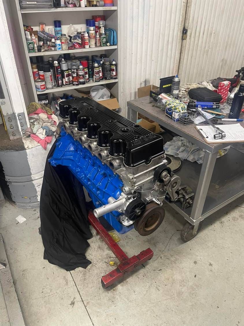 A Blue Engine is Sitting on Top of a Table in a Garage — Currie Bros Engine Reconditioners in Taree, NSW